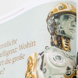 Das Bild zeigt eine Seite aus einem Buch oder Magazin mit der Abbildung eines Roboters in metallischem, mechanischem Design. Daneben steht der Text „Künstliche Intelligenz: Wohin führt die große Reise?“.